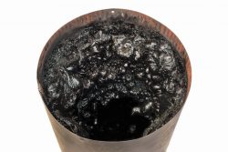 Picture of a creosote filled metal flue as an example of the need for a chimney cleaning