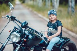 small girl on motorcycle as image for the blog post on motorcycle insurance