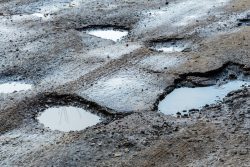 Image for post on pothole damage and whether car insurance will cover damage to a car